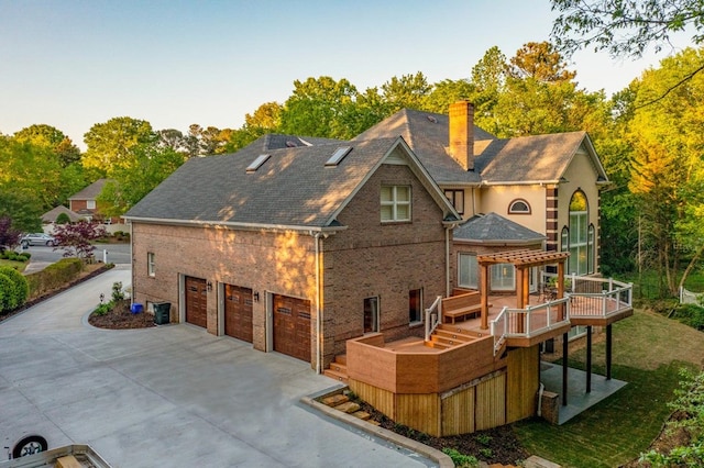 back of house featuring a wooden deck and a garage