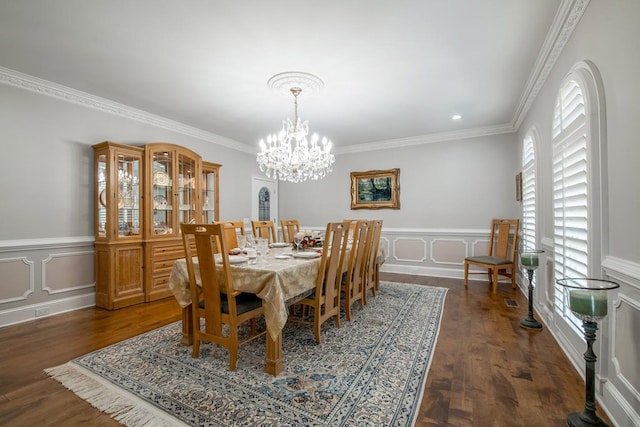 dining room featuring an inviting chandelier, crown molding, and dark hardwood / wood-style floors