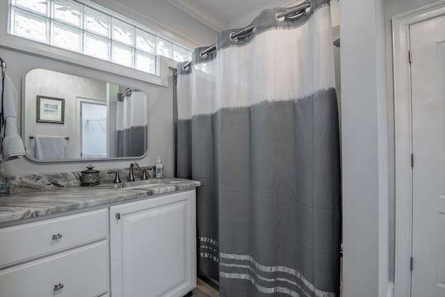 bathroom with crown molding and vanity