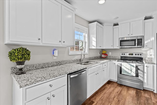 kitchen featuring stainless steel appliances, sink, white cabinets, and dark hardwood / wood-style floors