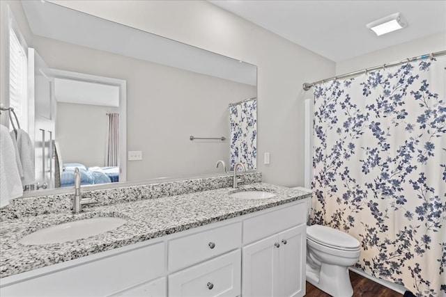 bathroom featuring hardwood / wood-style flooring, vanity, and toilet