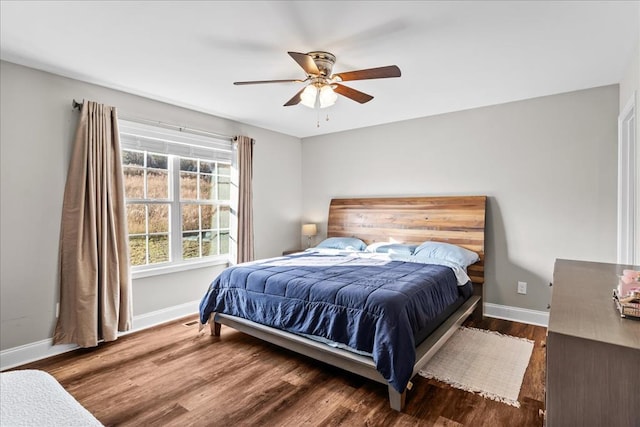 bedroom with dark hardwood / wood-style floors and ceiling fan