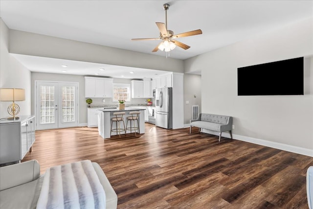 living room with wood-type flooring, french doors, and ceiling fan