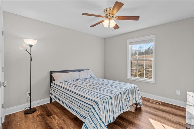 bedroom with hardwood / wood-style flooring and ceiling fan