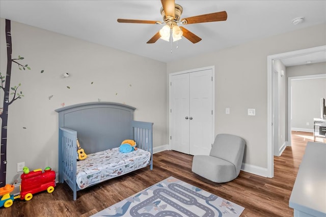 bedroom with hardwood / wood-style flooring, ceiling fan, and a closet