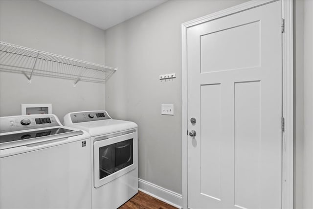 washroom featuring dark wood-type flooring and washer and dryer