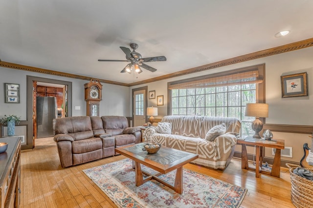 living room with recessed lighting, light wood-style floors, ornamental molding, ceiling fan, and a brick fireplace