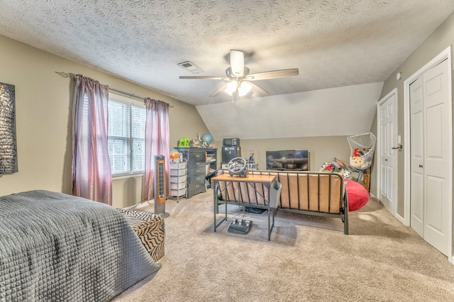carpeted office space featuring a textured ceiling and a ceiling fan
