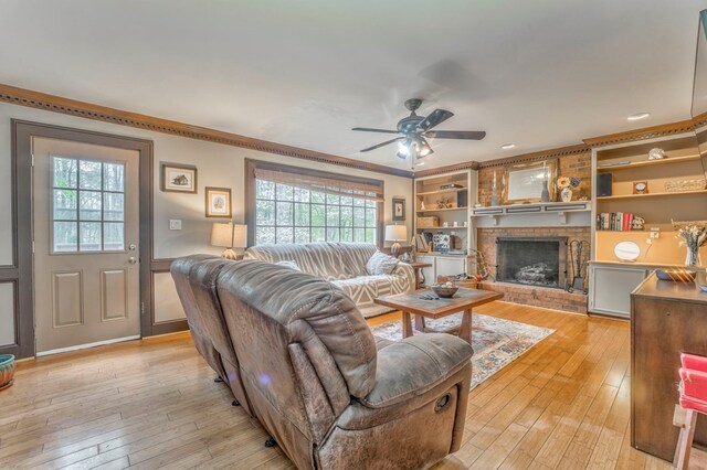 dining space with an inviting chandelier, a textured ceiling, light wood-style floors, and crown molding