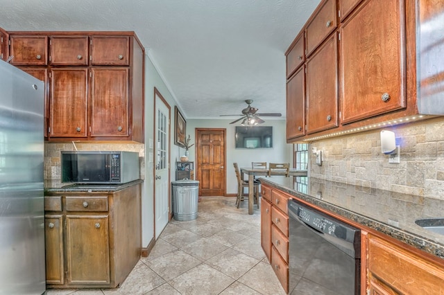 kitchen with dark stone counters, a sink, stainless steel range with electric stovetop, black dishwasher, and backsplash