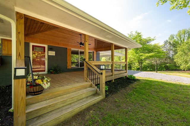 deck featuring a lawn, ceiling fan, and driveway