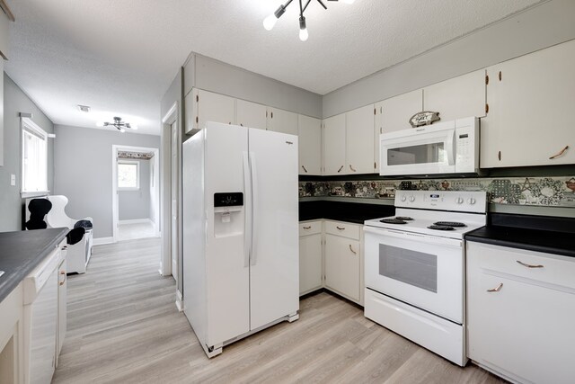 1113 Mount Vernon Rd, Tunnel Hill, GA 30755 - kitchen featuring dark countertops, light wood finished floors, white appliances, and white cabinetry