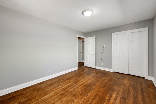 1113 Mount Vernon Rd, Tunnel Hill, GA 30755 - unfurnished bedroom with baseboards, dark wood-style floors, and a closet