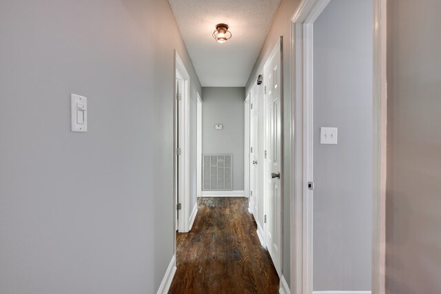 1113 Mount Vernon Rd, Tunnel Hill, GA 30755 - corridor featuring a textured ceiling, baseboards, visible vents, and dark wood finished floors