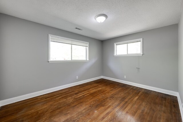 1113 Mount Vernon Rd, Tunnel Hill, GA 30755 - unfurnished room featuring baseboards, a textured ceiling, dark wood-style floors, and visible vents