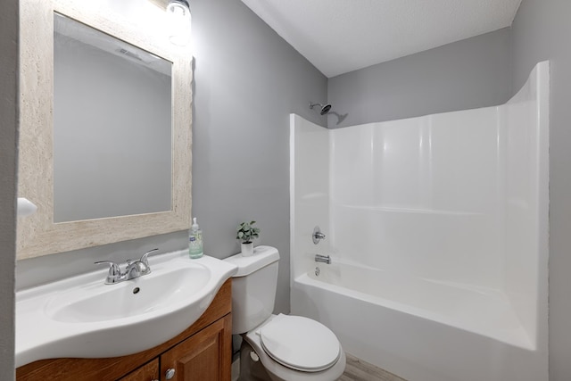 bathroom with toilet, washtub / shower combination, wood finished floors, and vanity