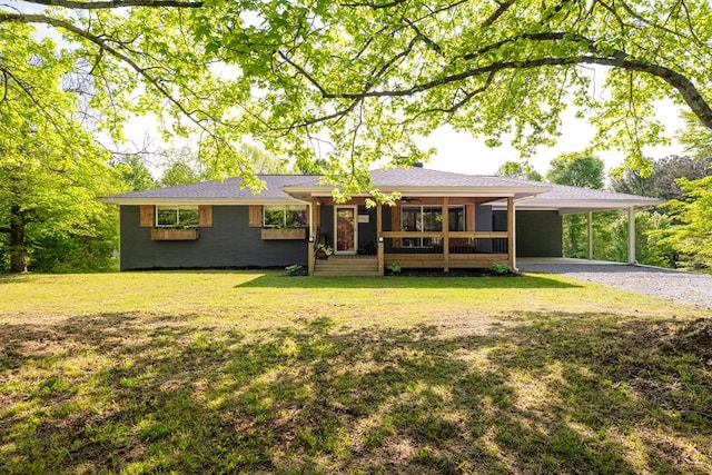 single story home featuring a porch, driveway, a front yard, and an attached carport