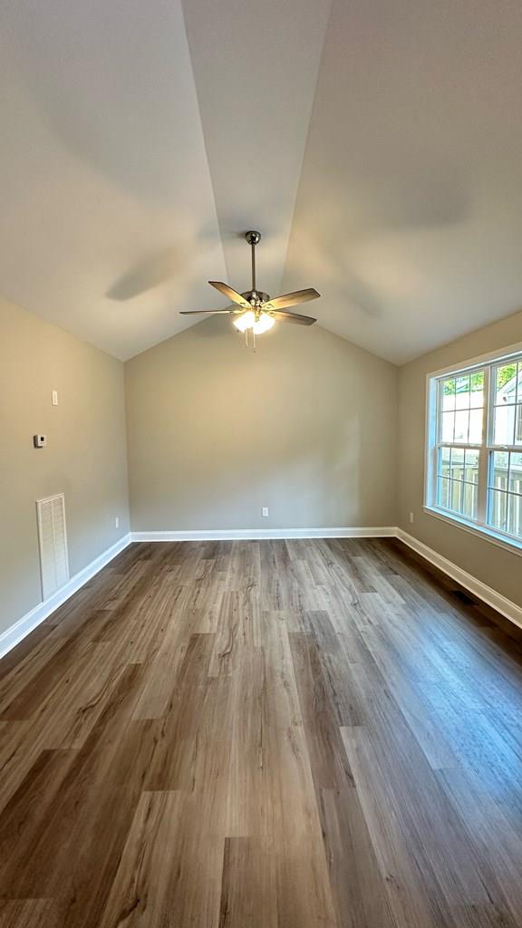 1420 Cleo Way, Dalton, GA 30720 - spare room with dark wood-style floors, ceiling fan, vaulted ceiling, and baseboards