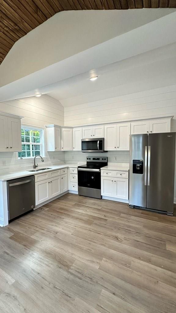 1420 Cleo Way, Dalton, GA 30720 - kitchen featuring stainless steel appliances, vaulted ceiling, a sink, light countertops, and white cabinets