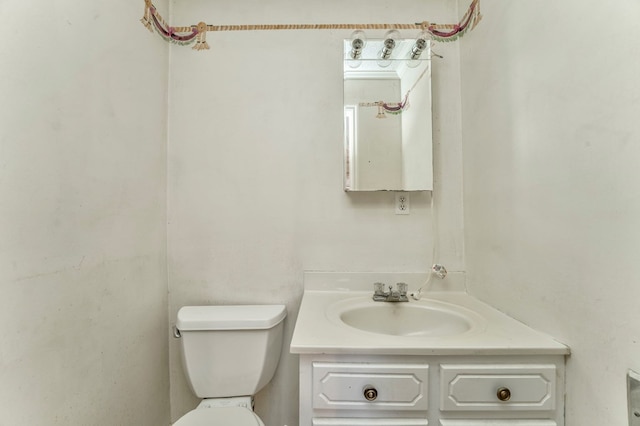 bathroom featuring toilet and vanity