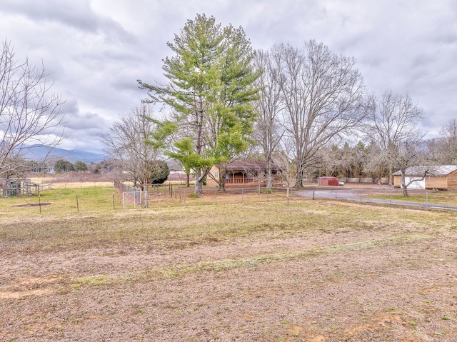 view of yard featuring a rural view and fence