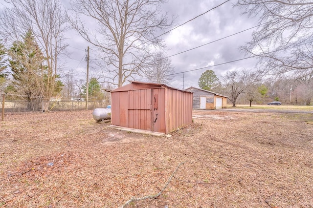 view of shed featuring fence