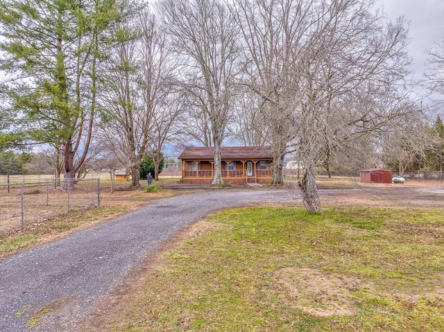 view of front of home with aphalt driveway, a porch, and fence