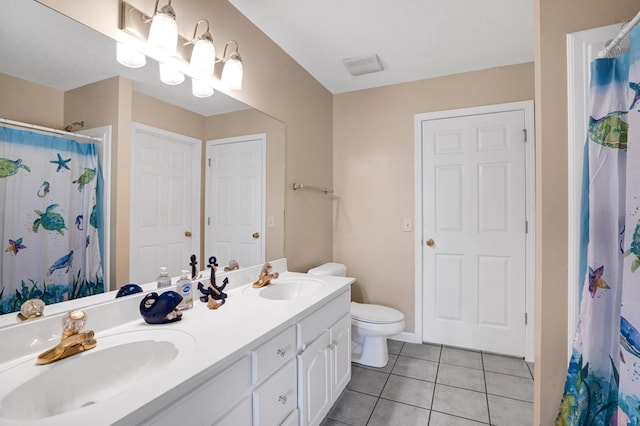 bathroom with tile patterned flooring, vanity, a shower with shower curtain, and toilet