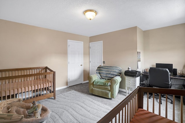 bedroom featuring carpet floors and a textured ceiling