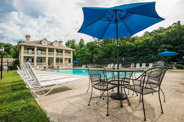 view of swimming pool with a patio