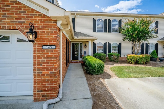 view of exterior entry with a garage