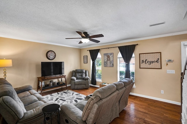 living room featuring ceiling fan, ornamental molding, dark hardwood / wood-style flooring, and a textured ceiling