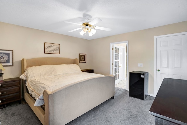 carpeted bedroom featuring a textured ceiling and ceiling fan