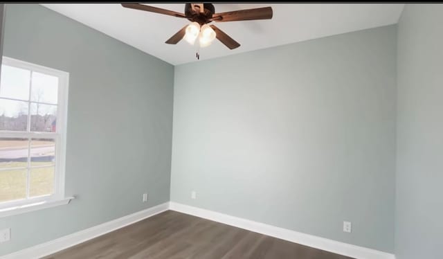 unfurnished room with dark hardwood / wood-style flooring and ceiling fan