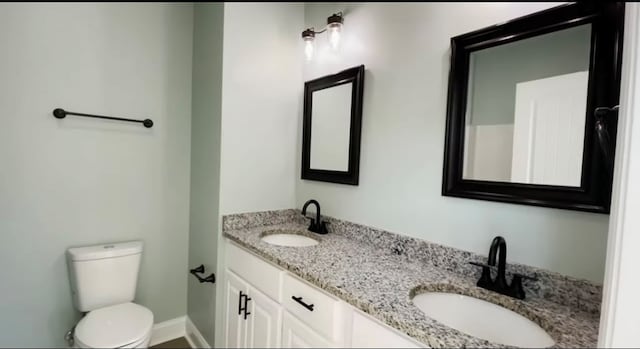 bathroom featuring vanity and toilet