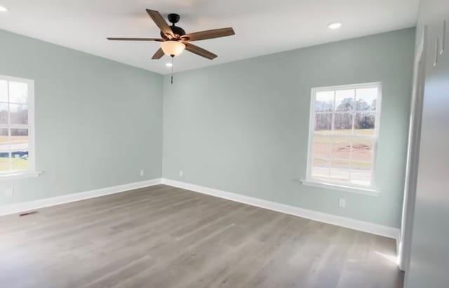 spare room with wood-type flooring and ceiling fan