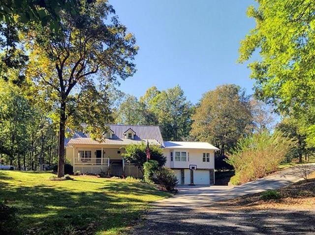 view of front of house with a garage, a porch, and a front yard