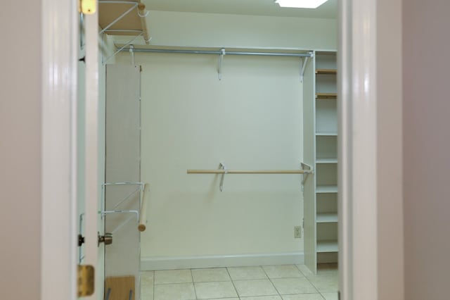 spacious closet with light tile patterned floors