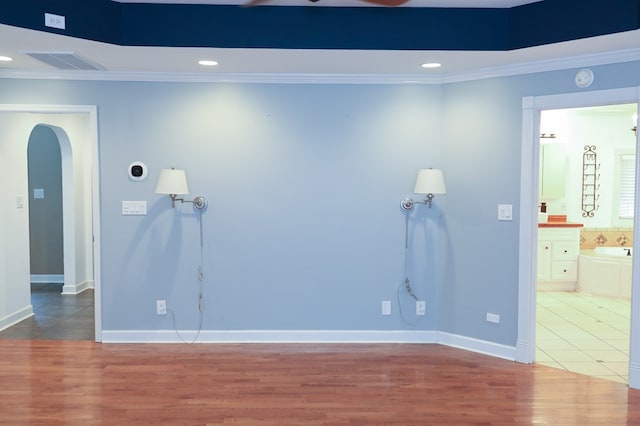 spare room featuring ornamental molding and hardwood / wood-style floors