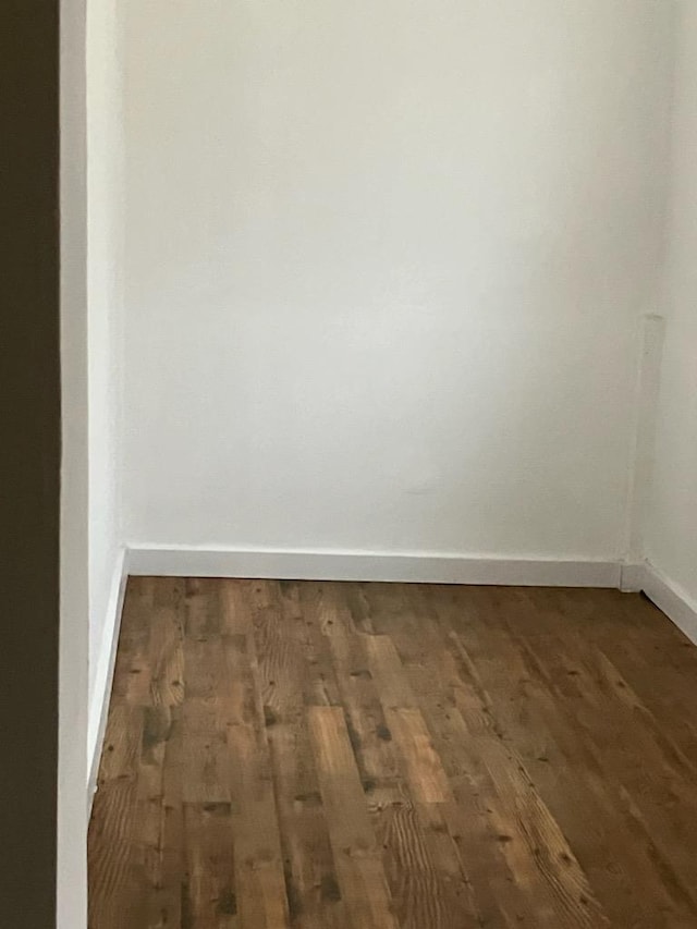 empty room featuring dark wood-type flooring