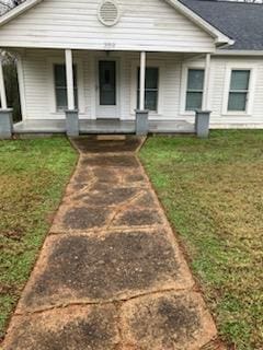 view of front of property with a porch and a front lawn