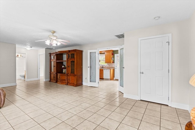 tiled spare room featuring ceiling fan