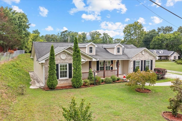 new england style home with a porch and a front lawn