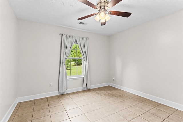 tiled empty room with a textured ceiling and ceiling fan