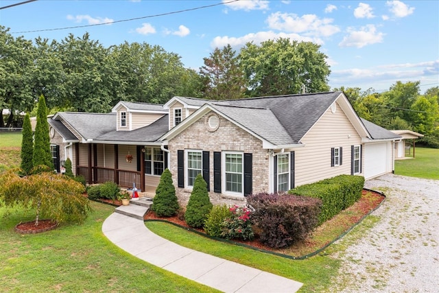 view of front of home with a garage, a front yard, and a porch