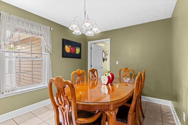 dining area featuring light tile patterned floors, a chandelier, and a healthy amount of sunlight