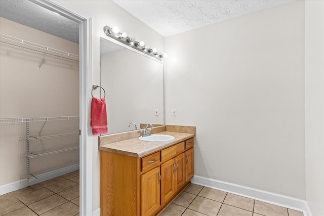 bathroom with vanity, tile patterned floors, and a textured ceiling