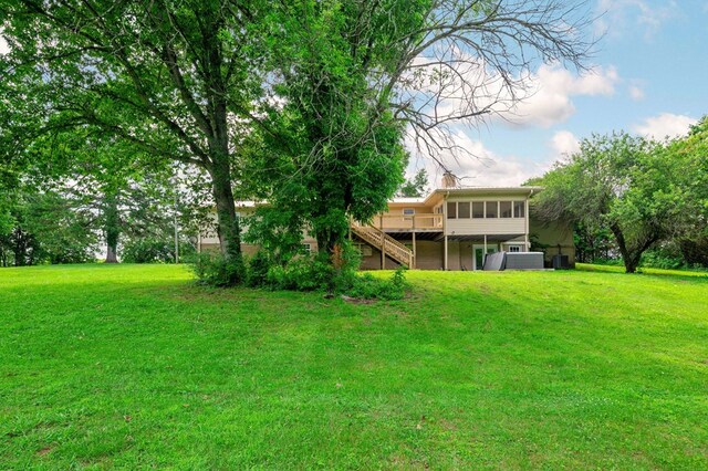 3414 Chattanooga Rd, Tunnel Hill, GA 30755 - view of green lawn with stairs, a sunroom, and a wooden deck