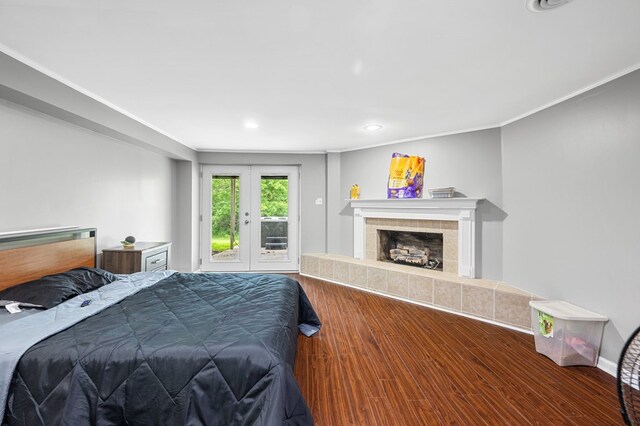 3414 Chattanooga Rd, Tunnel Hill, GA 30755 - bedroom with wood finished floors, a tiled fireplace, french doors, recessed lighting, and ornamental molding