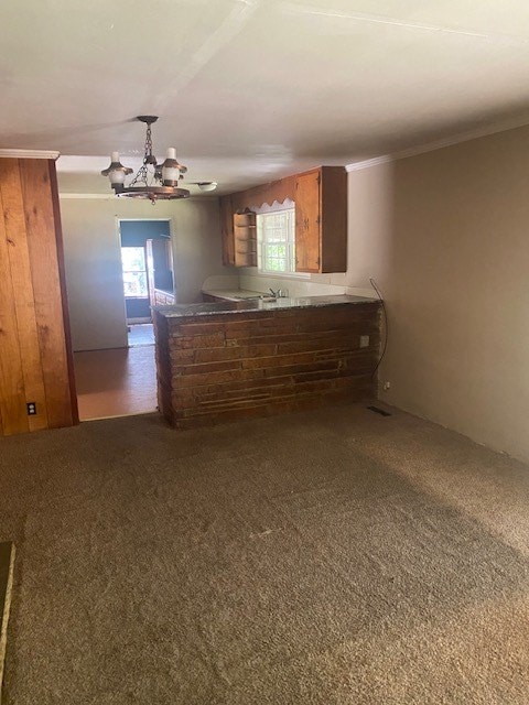 kitchen featuring hanging light fixtures, plenty of natural light, carpet floors, and an inviting chandelier